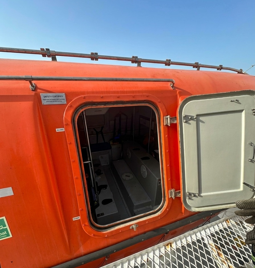 Open TEMPSC lifeboat boarding door during offshore evacuation